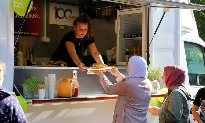 Zwei Damen bekommen Essen aus unserem Machbarschaftsmobil gereicht.